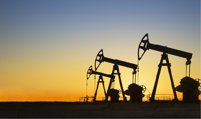 Oil rigs silhouetted against a sunset in west Texas
